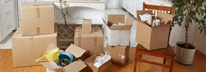 Packed moving boxes and household items in a kitchen before move-out or move-in cleaning, Yonkers, NY.